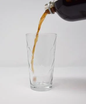 Cola drink pouring Stock Photos
