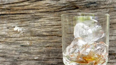 Cola drop in glass on old backgrounds  Stock Footage 81934274