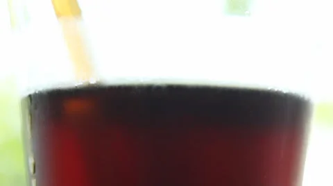 Cola drunk from glass using drinking straw Stock Footage 35884035