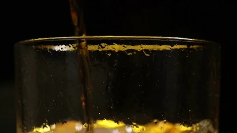 Cola is filled in a glass with ice in front of black background Stock Footage 85436217