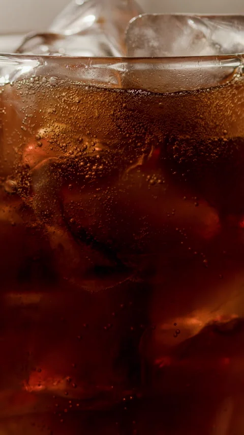 Cola Glass filled with Ice Cubes and Bubbling Liquid Vertical Stock Footage 335865247