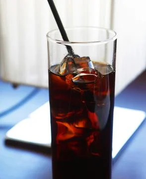 Cola glass with ice cubes on table Stock Photos