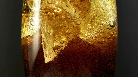 Cola with ice and bubbles in the glass. Close up soda soft drink. Slow motion. Vídeos de archivo 38997276