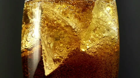 Cola with ice and bubbles in the glass. Close up soda soft drink. Slow motion. Vídeos de archivo 39000102