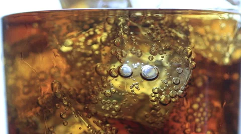 Cola with Ice and bubbles in glass. Soda closeup. Food background Video stock 63125455