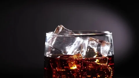 Cola with Ice and bubbles in glass slow motion. Stock Footage 82125237