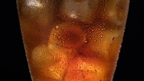 Cola with ice. close-up for glass of cold coke with ice cubes rotation Stock Footage 77085731
