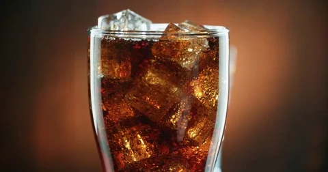 Cola with ice. close-up for a very large glass of cold coke with ice cubes Video stock 72986175