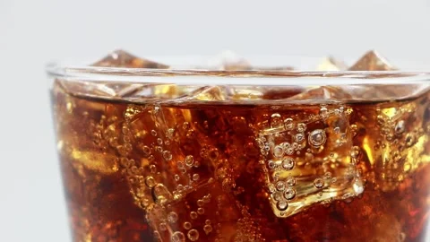 Cola with ice cubes close-up. Cola with Ice in glass. Coke Soda closeup. Stock Footage 195098130