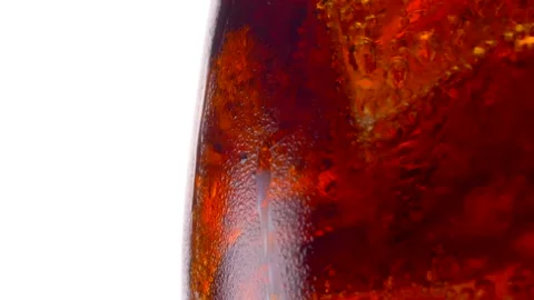 Cola with ice cubes close-up. Cola with Ice and bubbles in glass. Stock Footage 231034984