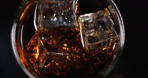 Cola with ice cubes  is poured on black background 스톡 동영상 133628398