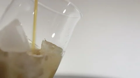 Cola with ice. Pouring Cola with Ice and bubbles in glass. Video stock 61447489