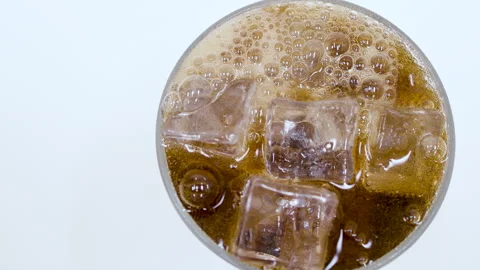 Cola or Dark Soda Poured Over Ice in Glass Closeup Stock Footage 340124044
