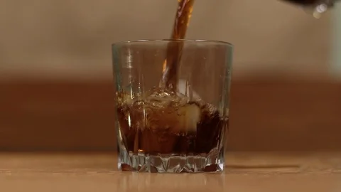 Cola pouring into a glass with ice Stock Footage 120797210