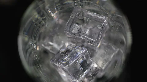 Cola pouring onto ice cubes Stock-Footage 232843358