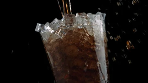 Cola Pouring Over Ice Cubes in Glass, Close Up Vídeos de archivo 346088512