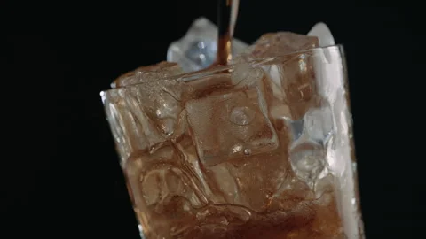 Cola Pouring Over Ice Cubes in Glass, Close Up Stock Footage 346088735