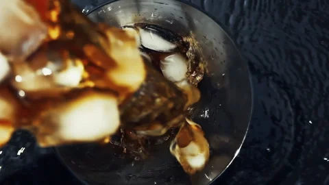 Cola Pouring Over Ice in Glass, Top-Down Close Up Stock Footage 346088051