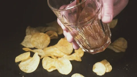 Cola pours into a glass over chips slow motion Stock Footage 87795142