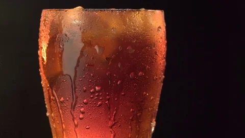 Cola soda in glass with texture on a black background Stock Footage 77094430