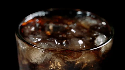 Cola Soda with Ice Cubes Close-Up in Glass on Black Background Stock Footage 346086155
