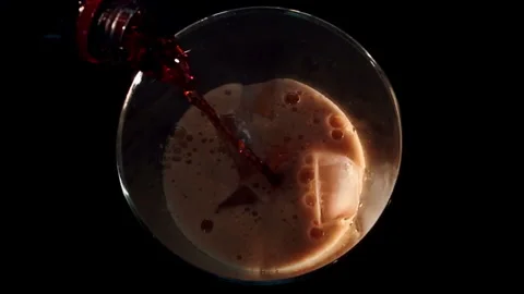 Cola Soda Pouring Over Ice, Top-Down View Stock Footage 346088017
