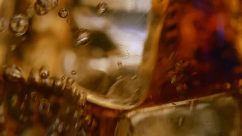 Cola with swirling ice cubes bubbles and ice cubes in glass Stock-Footage 122266978