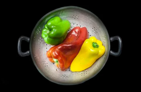 Colander with capsicums Stock Photos