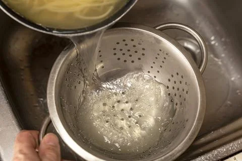 Colander with fresh cooked spaghetti in kitchen Stock-Fotos