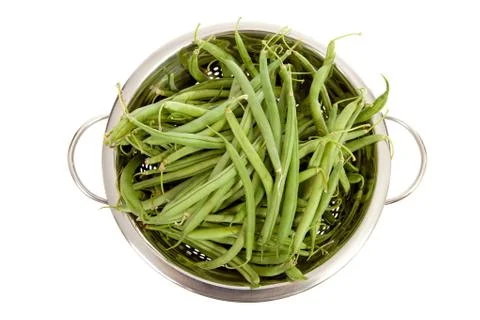 Colander with long green beans Stock Photos