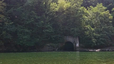 Cold Air Forms Steam at Tunnel Mouth on Mountain Lake Outdoors Stockbeeldmateriaal 343538130