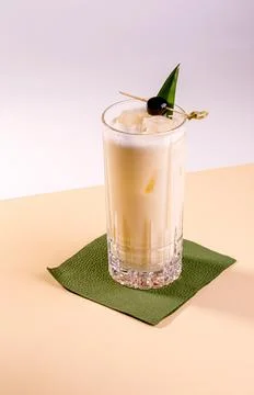 Cold alcoholic or non-alcoholic cocktail on pastel background. Hard light, .. Stock Photos