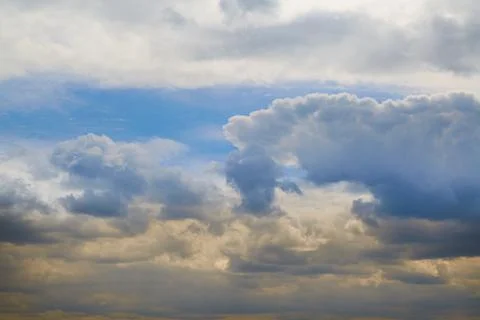 Cold and warm light on clouds in the sky, contrast of light in the sky Stock Photos