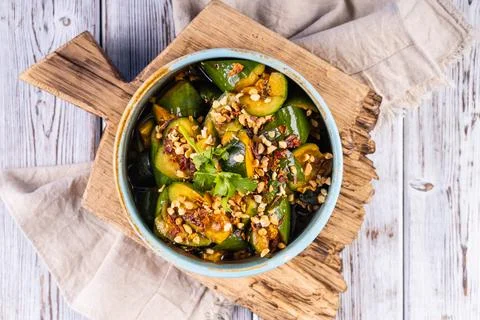 Cold appetizer "Broken cucumbers" in chill sauce. Stock Photos