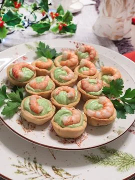 Cold appetizer for holiday table. Shortcrust pastry baskets with shrimp and Stock Photos