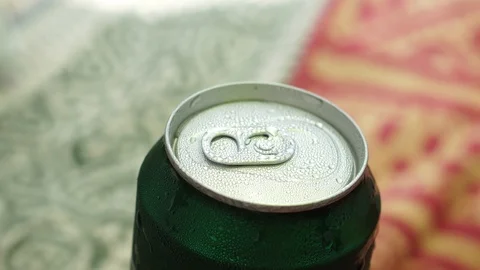 Cold beer on the beach. Drops of condensate on the iron can. Heat. 4k Stock Footage 99402899