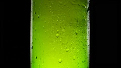 Cold beer bottle dripping condensate on black background Stock Footage 155686272
