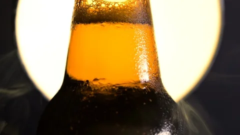 Cold Beer Bottle  Water Drops, smoke fog sun or moon vintage  background 動画素材 128772131