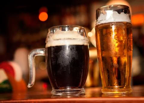 Cold beer with foam Stock Photos