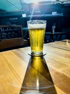 A cold beer glass is on the table. Stock Photos