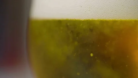 Cold beer pouring into glass with bubbles and foam Video stock 333114261