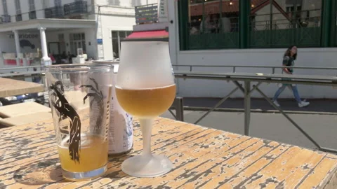 Cold beer waiting on table on bright summer day Stock Footage 137973181