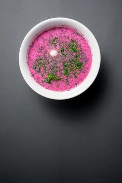 Cold beetroot soup with cucumber, boiled egg, dill and yogurt in white bowl Stock Photos