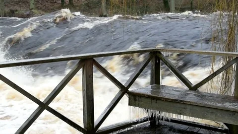 Cold bench by the river Stock Footage 84759981