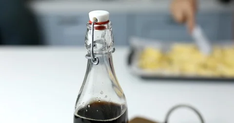 Cold beverage in glass bottle on table in kitchen Stock Footage 112037599