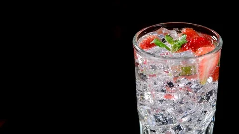 Cold beverage with Strawberry and mint on a black background closeup Stock Footage 91893073