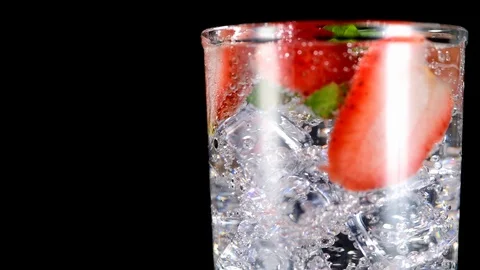 Cold beverage with Strawberry and mint on a black background closeup Video stock 91893114