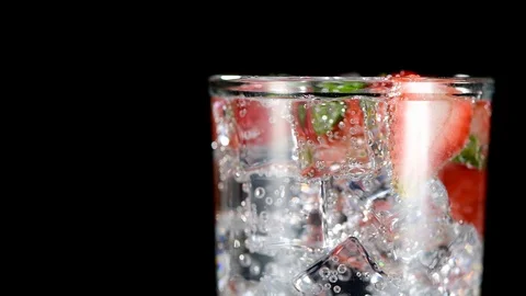 Cold beverage with Strawberry and mint on a black background closeup Stock Footage 91893270