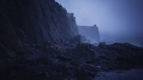 Cold blue lighting highlights layered geological textures and dramatic isolation Stock Footage 339616193