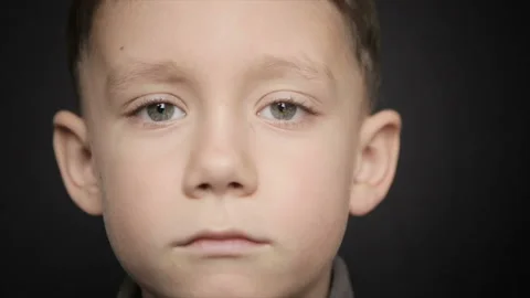 A cold boy close-up on a black background Stock Footage 127710474